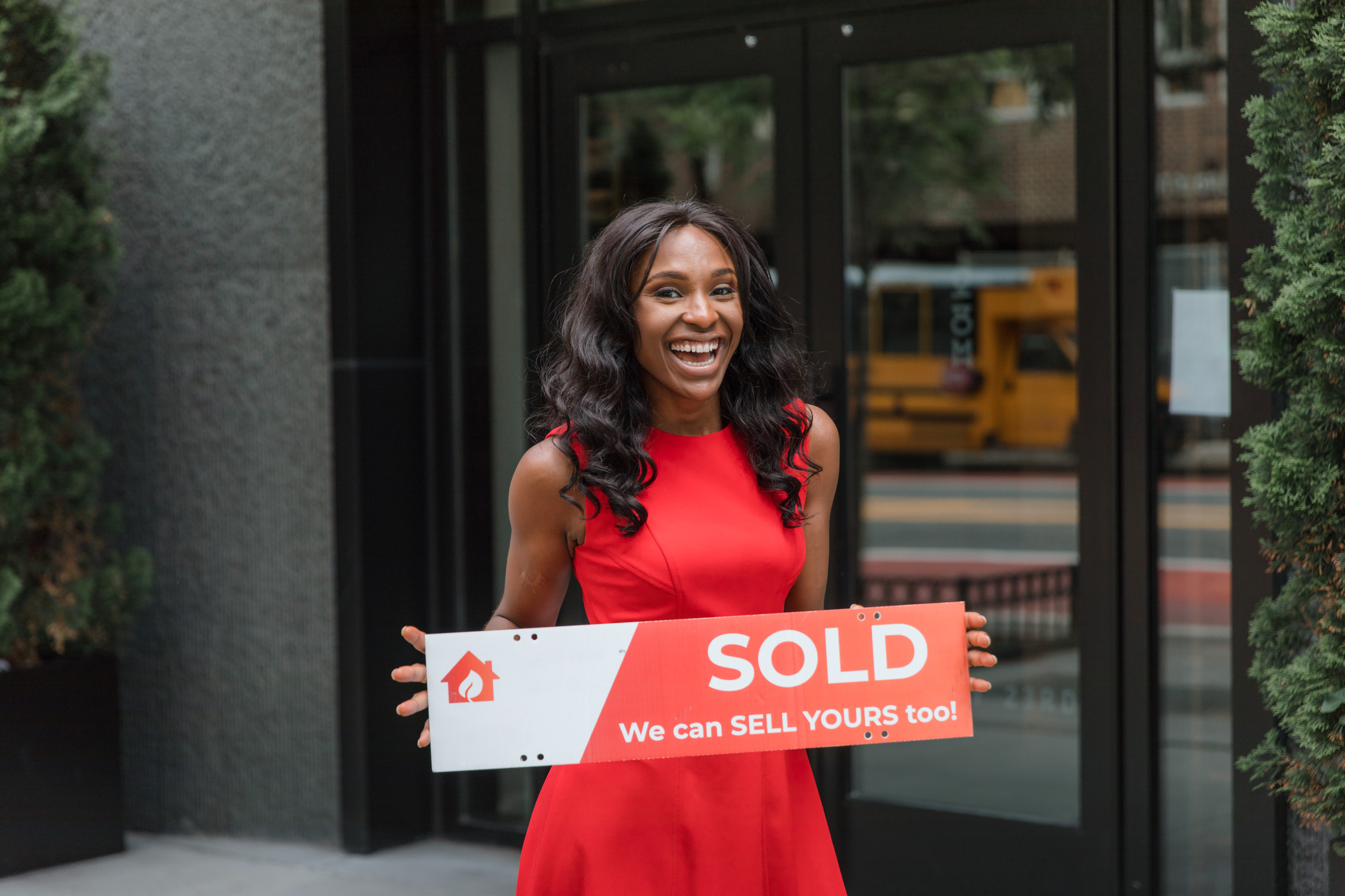 ocr-woman-holding-sold-sign.jpg